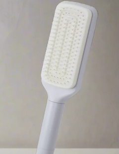 White paddle hairbrush with soft bristles for gentle detangling and daily grooming