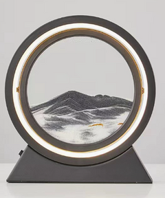 Circular LED-lit sand art decor with mountain landscape, modern home accent piece