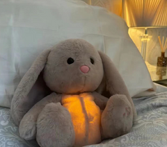 Cozy gray plush bunny with glowing belly, perfect family gift for bedtime comfort
