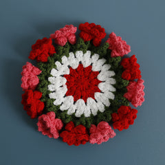 Handmade crochet flower coaster in red, pink, white, and green—perfect gift for home decor or family