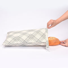 Plaid bread bag with clip closure holding fresh loaf, kitchen storage solution