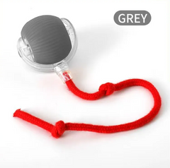 Grey handheld massager with red cord, ideal for relaxation and muscle relief