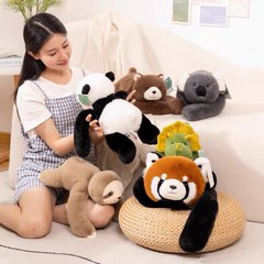 Woman holding panda plush toy surrounded by cute stuffed animals including red panda, koala, sloth, and dinosaur for family gifts
