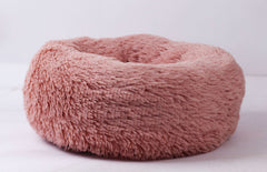 Soft pink fluffy pet bed for cozy comfort at home