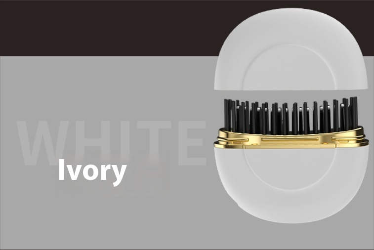 Ivory travel hairbrush with gold trim and black bristles, compact design for portable grooming