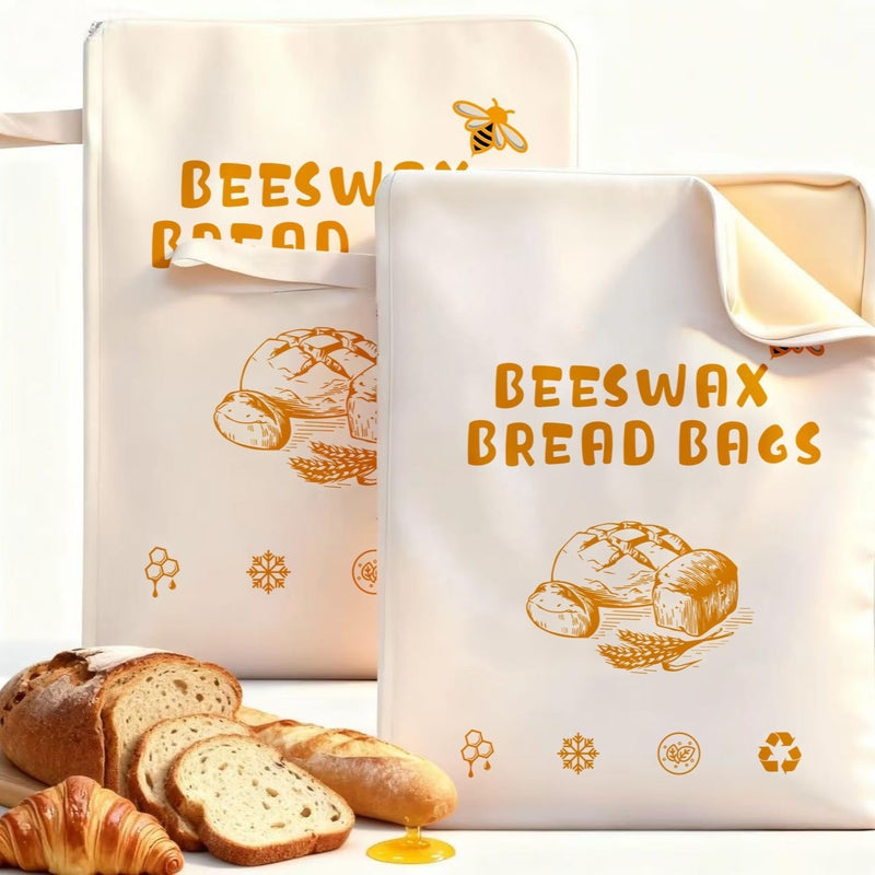Beeswax bread bags with orange print, holding fresh bread and croissants, eco-friendly storage for kitchen use