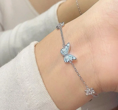 Delicate butterfly charm bracelet with light blue enamel wings, perfect gift for her