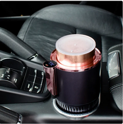 Rose gold car coffee maker with digital temp display, brewing in vehicle cup holder