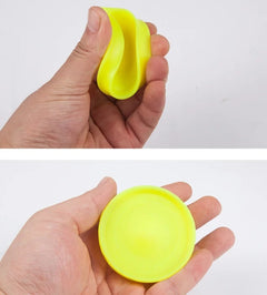 Bright yellow stress ball being squeezed and held, perfect for anxiety relief and fun gifts