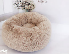 Cozy beige fluffy pet bed with soft texture, perfect for cats or small dogs
