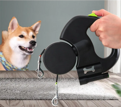 Black retractable dog leash with bone design, held in hand beside happy Shiba Inu on rug